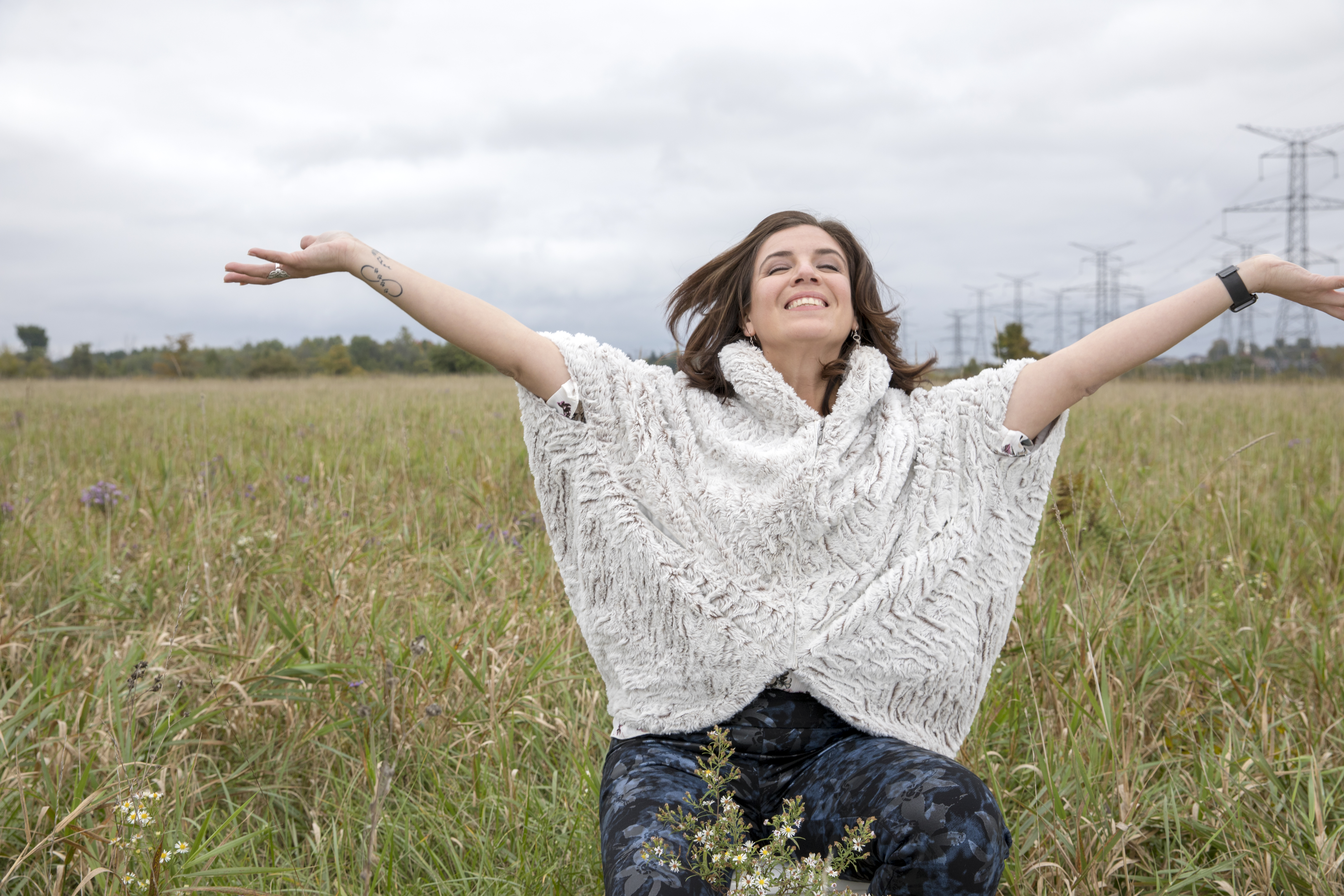 Ibeth Ayala — open arms in a field